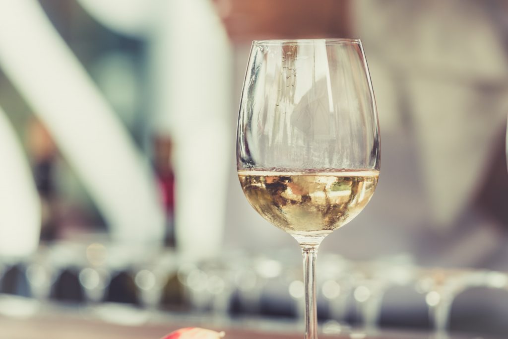white wine with empty glass on the background