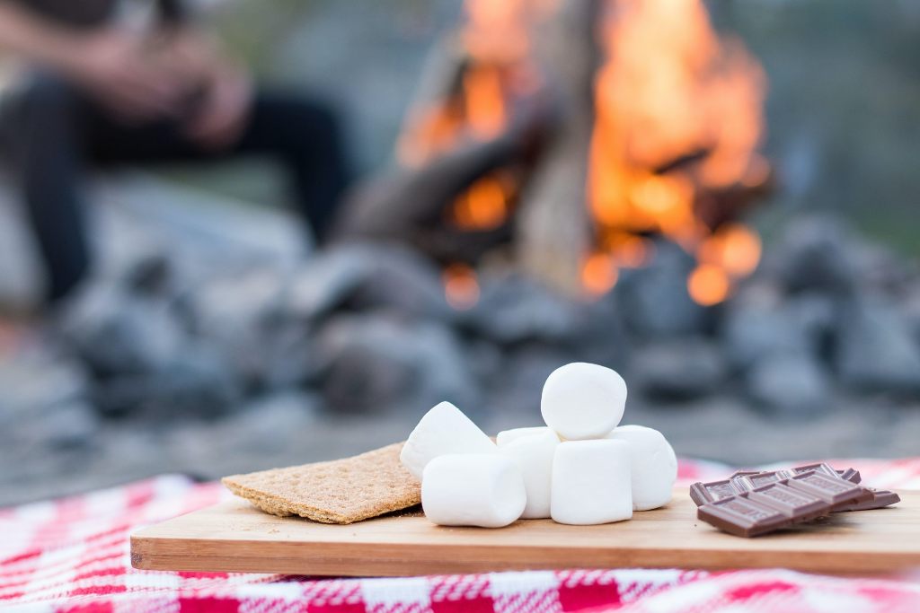 Graham crackers, marshmallows, and chocolate pieces for making s'mores, one of the most popular camping snacks.
