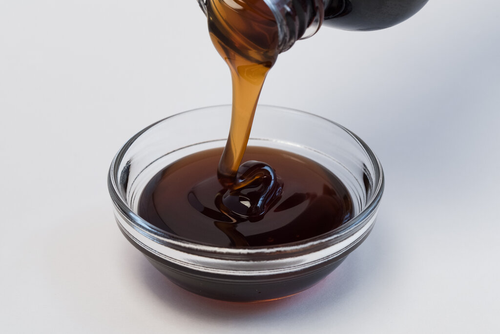 Pouring of corn syrup into a bowl