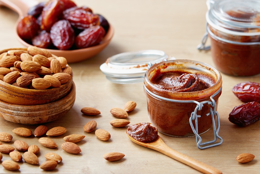 Date paste with scattered dates and almonds all around