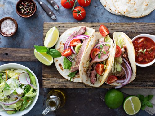 steak tacos on wooden table, leftover steak recipes
