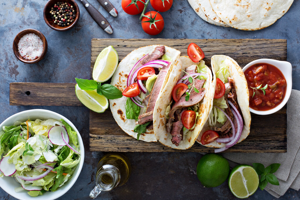 steak tacos on wooden table, leftover steak recipes