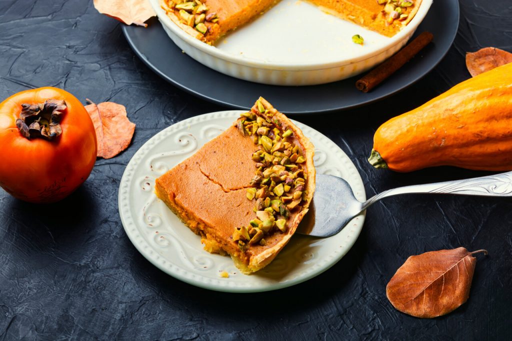 Persimmon Pie Recipe, Slice of persimmon pie with nuts on top