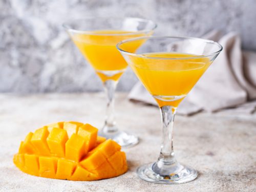 A simple mango cocktail in a martini glass.