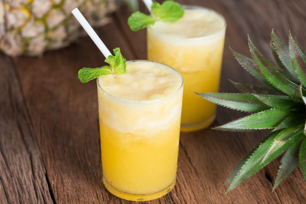 Tropical drink, Pineapple smoothie in glass with fresh pineapple