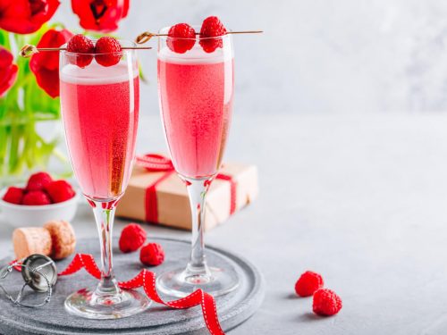 ink cocktail with champagne or prosecco and fresh raspberries for Valentine's day.
