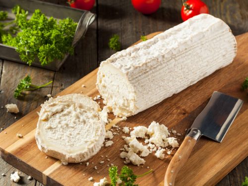 fresh white goat cheese on chopping board