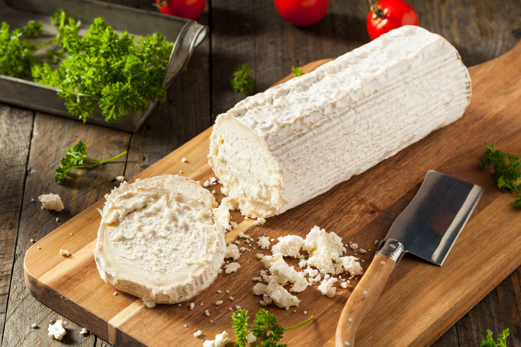 fresh white goat cheese on chopping board