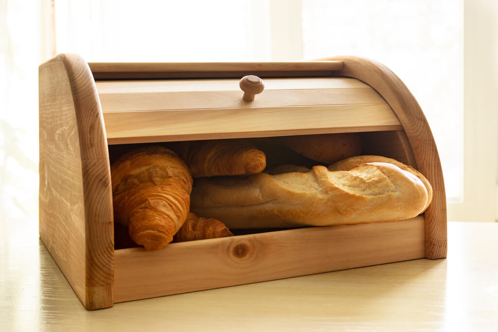 baked goods in wooden bread box