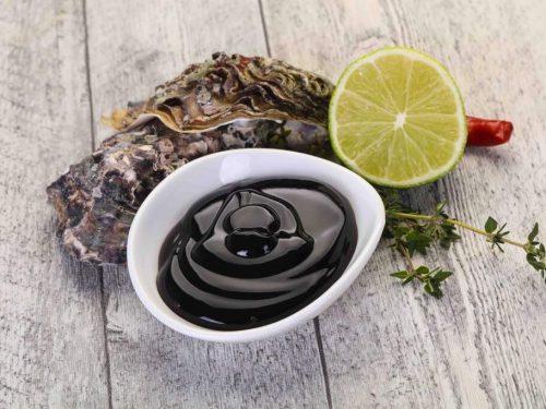 bowl of oyster sauce on wooden table