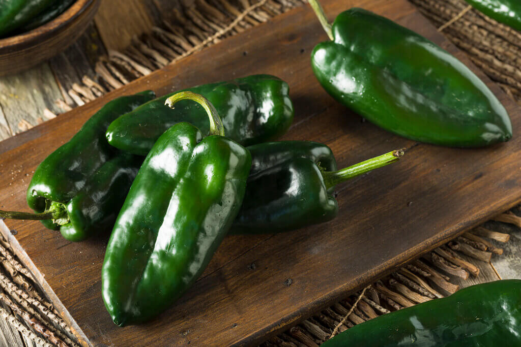 poblano peppers on a wooden board