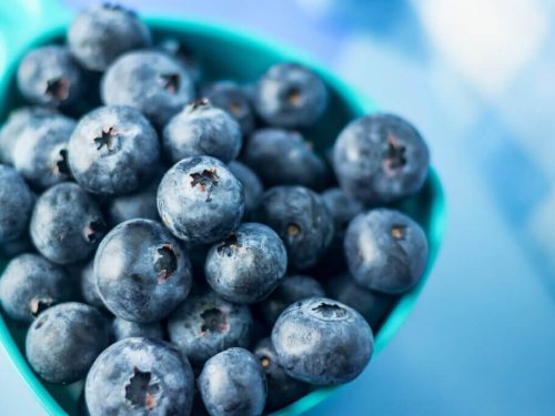 high angle view of blueberries in a blue container