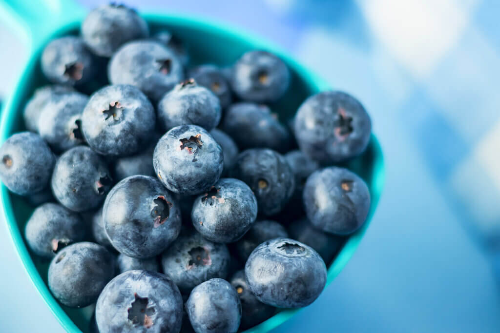 high angle view of blueberries in a blue container