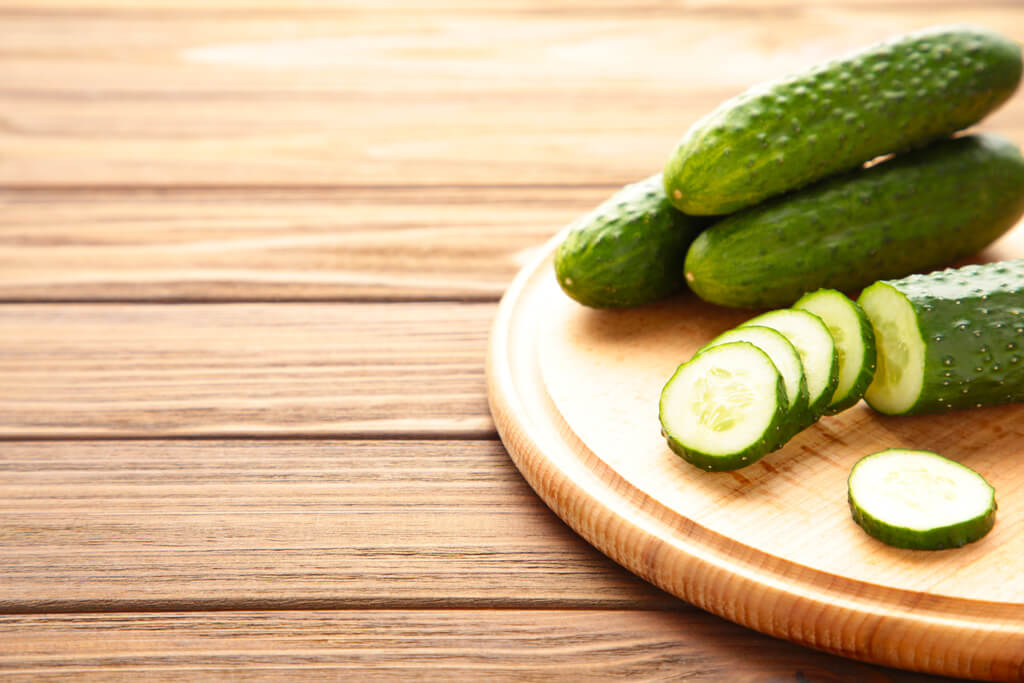 cucumber slices on wooden chopping board