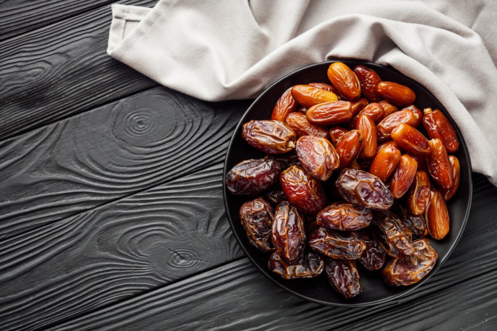 a plate of dates on a black blackground