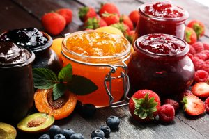 assortment of fruit preserves in jars, jam vs jelly