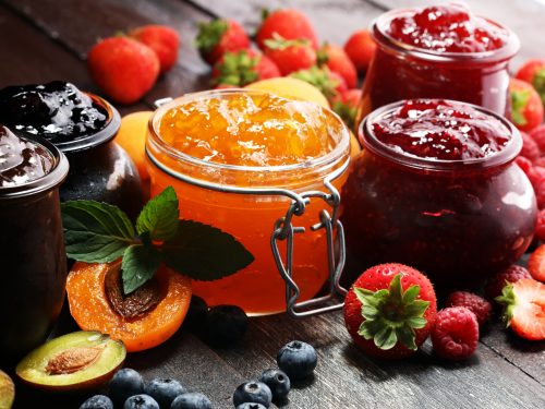 assortment of fruit preserves in jars, jam vs jelly 