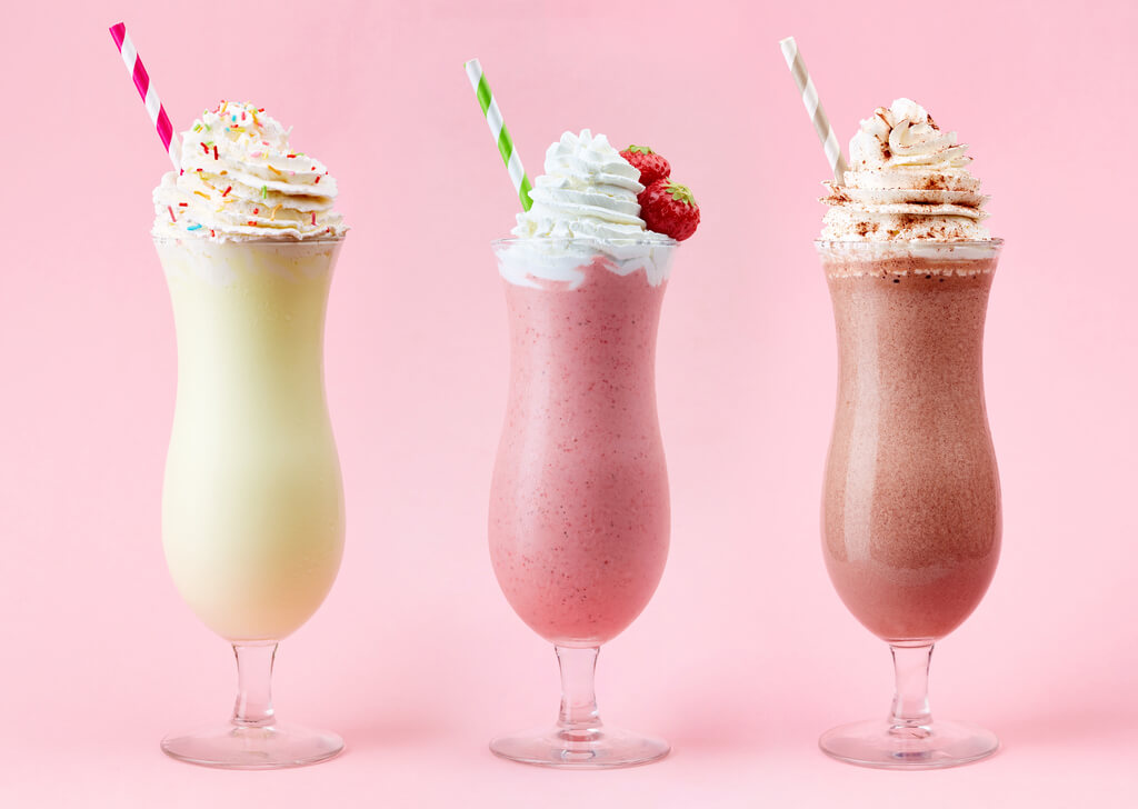 vanilla, strawberry, and chocolate milkshake on pink background, malt vs shake