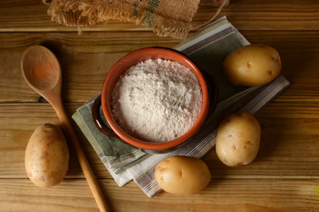 potato starch in a bowl surrounded by potatoes, potato starch substitute