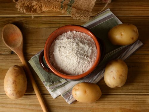 potato starch in a bowl surrounded by potatoes, potato starch substitute