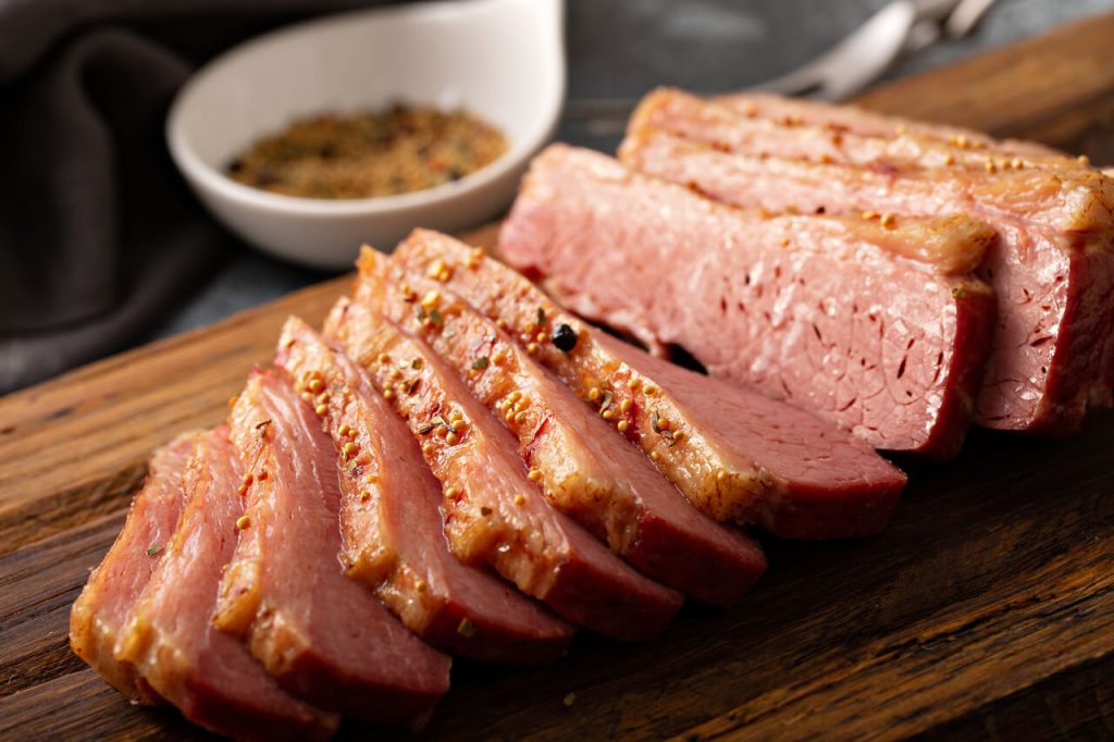 Corned beef brisket on wooden chopping board