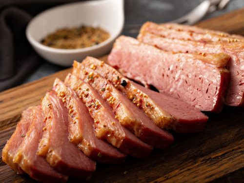 Corned beef brisket on wooden chopping board
