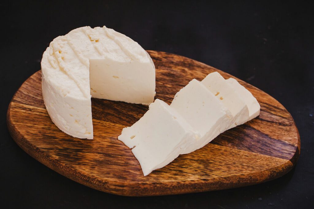 queso fresco on wooden chopping board