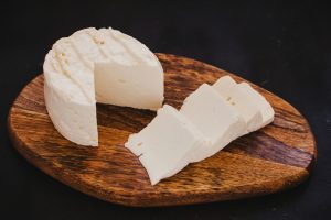 queso fresco on wooden chopping board