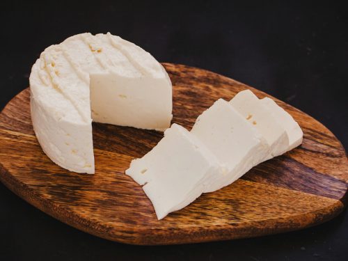 queso fresco on wooden chopping board