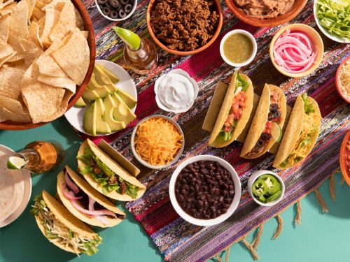 a spread of taco essentials for a taco bar, best taco toppings