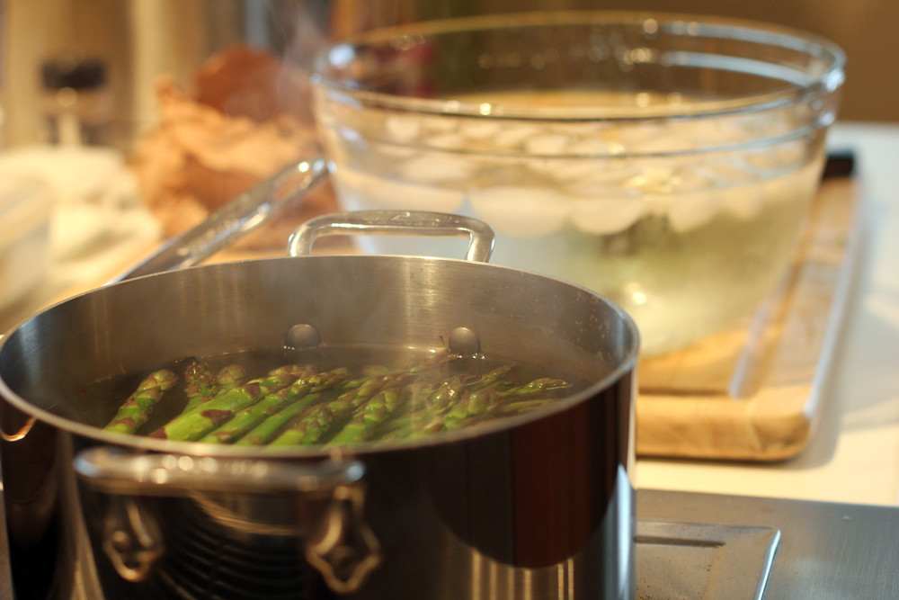 blanching asparagus stalks on a large stock pot