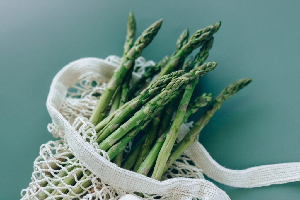 fresh asparagus stalks in a mesh bag