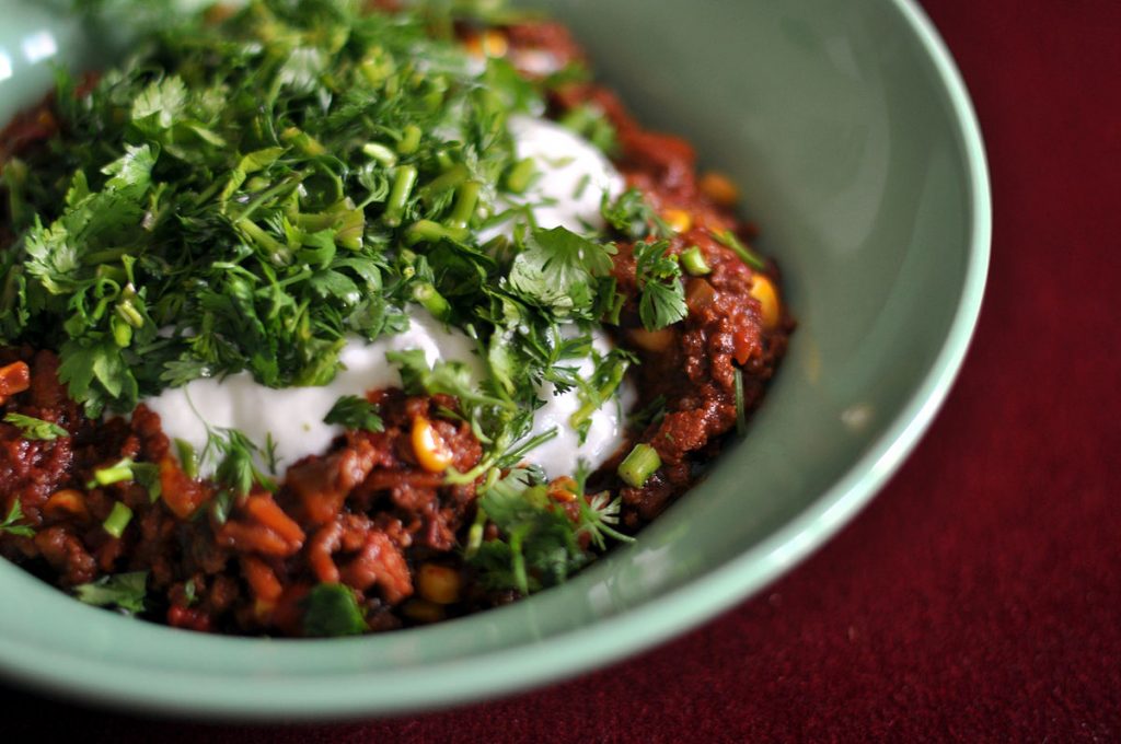bowl of chili corn carne with chili toppings