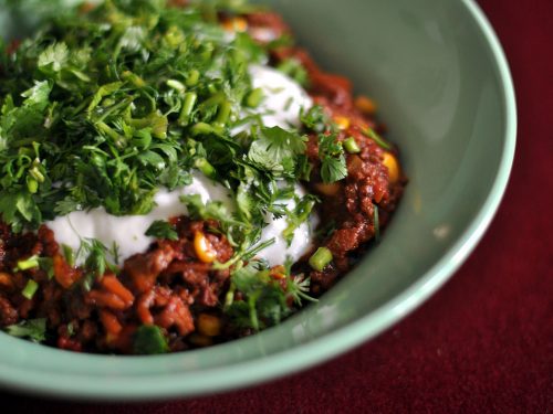 bowl of chili corn carne with chili toppings