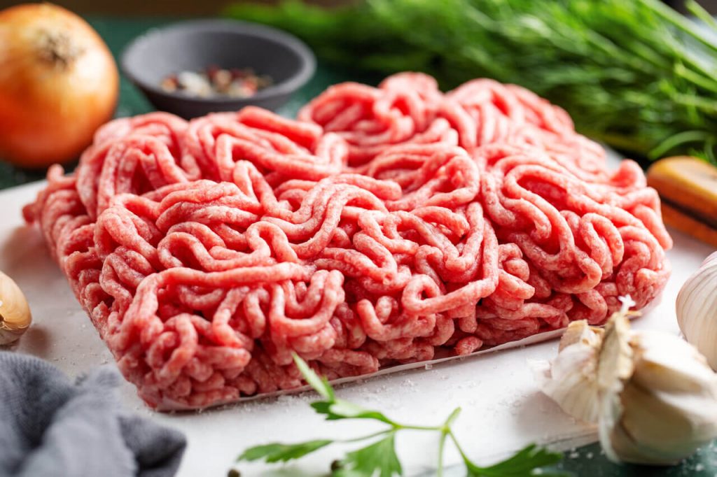 Ground beef with ingredients on the table