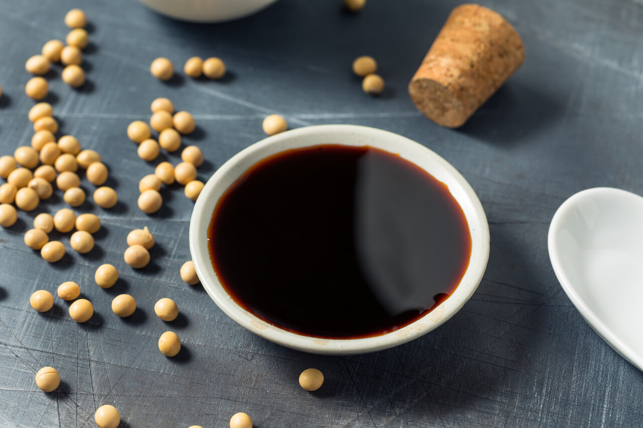 dark tamari sauce in a small white bowl