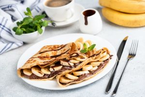 french crepes filled with chocolate syrup and banana slices, crepe fillings