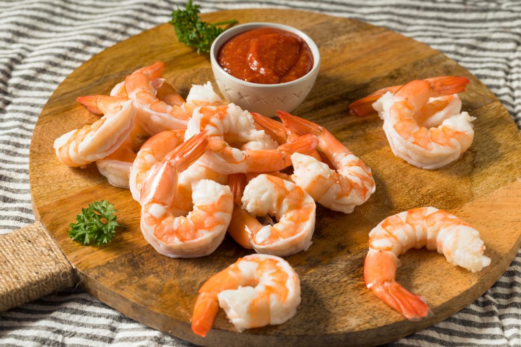 a plate of homemade shrimp appetizer with sauce, shrimp appetizers