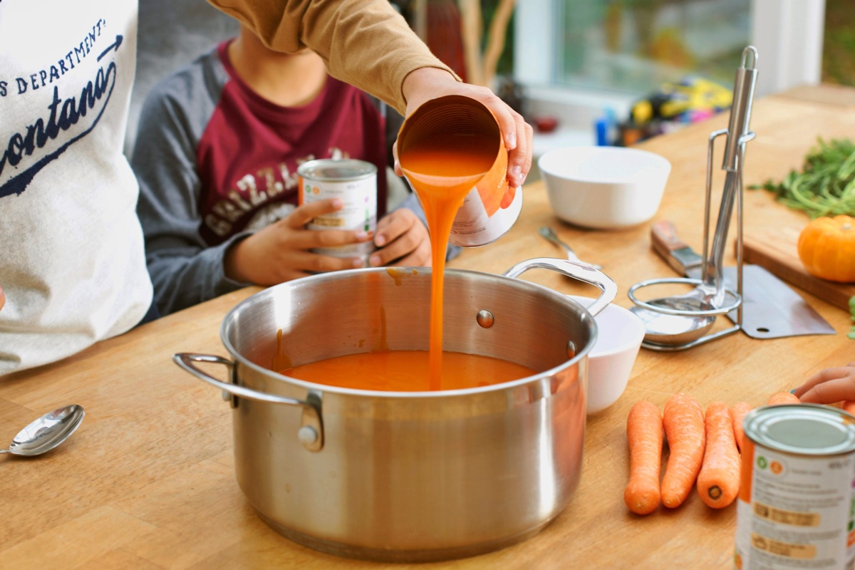 Pot with boiling soup or sauce, saucepan with open lid. Cooking