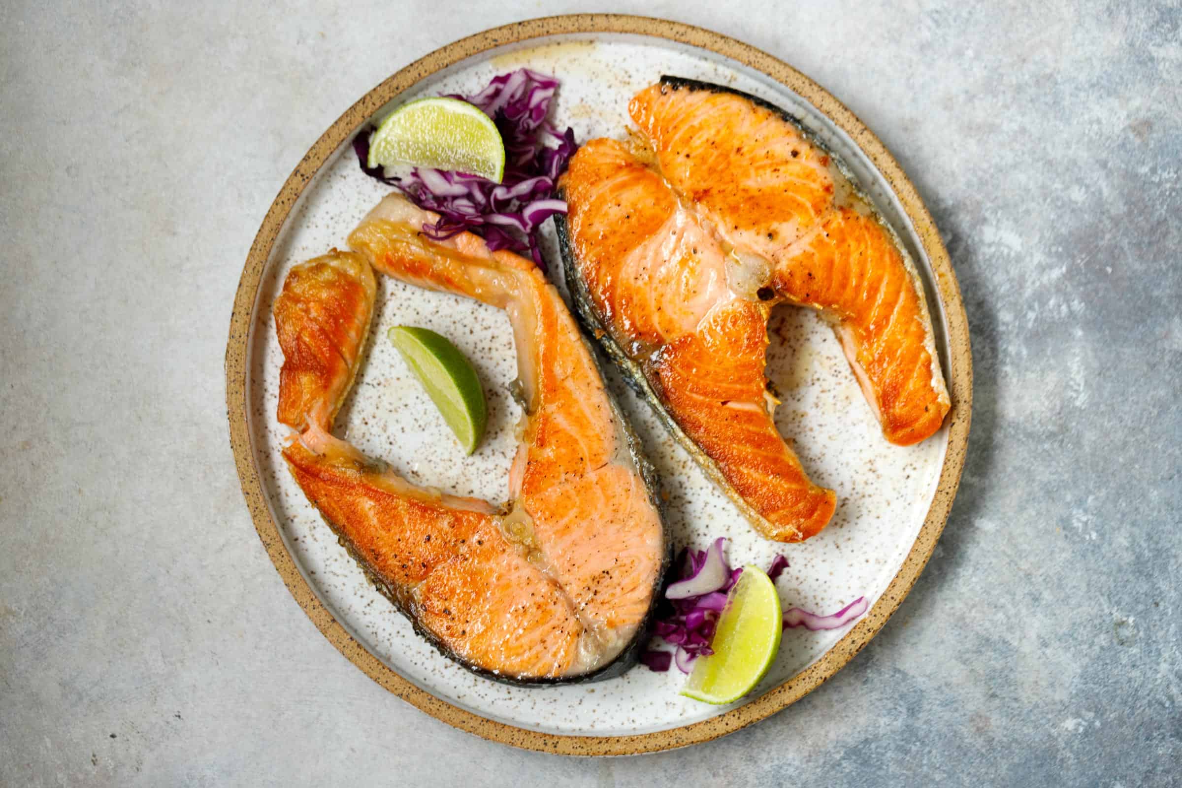 Grill pan with delicious salmon steaks on stove in kitchen Stock