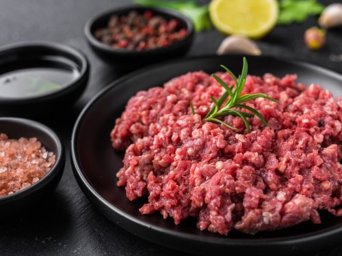 Fresh minced meat ground beef on a black plate