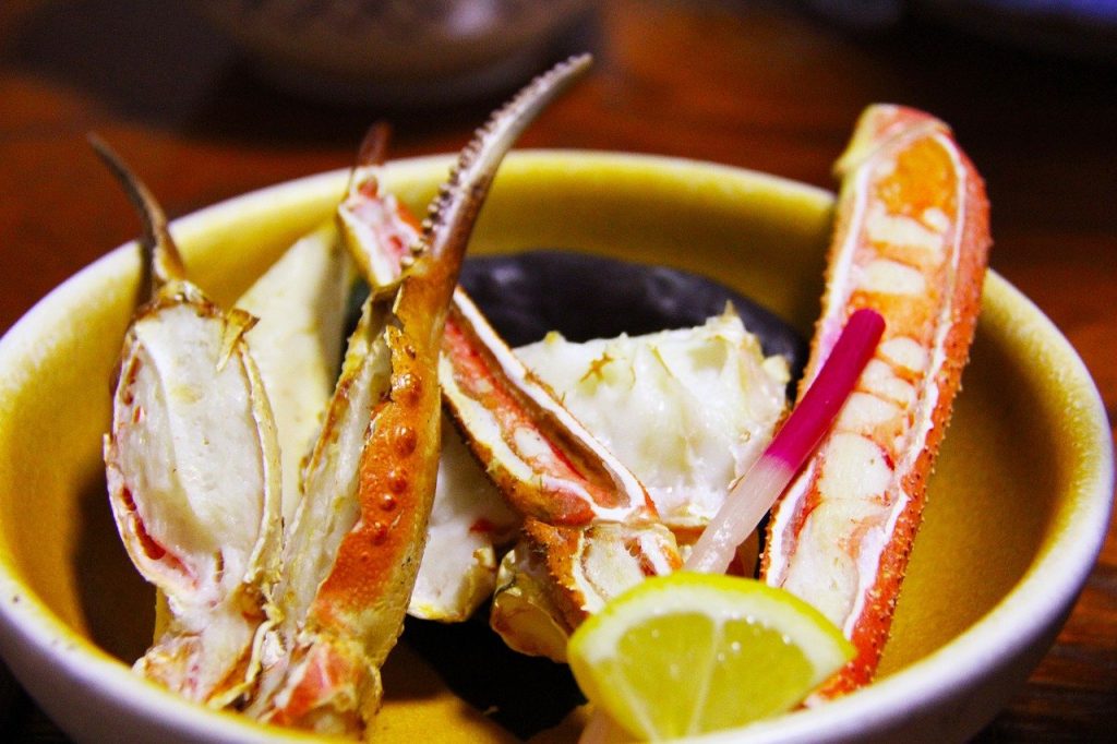 close-up shot of grilled crab legs with lemon