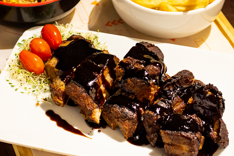 Barbecued Teriyaki Pork Tenderloin Recipe - Grilled pork tenderloin medallions topped with teriyaki sauce and vegetables on the side