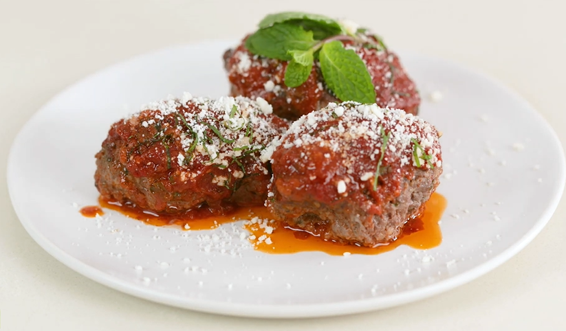 lamb meatballs with cumin, mint, and tomato sauce