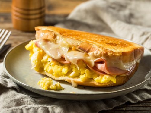 Moons Over My Hammy Recipe (Denny's Copycat), delicious egg sandwich with ham and melting cheese in betwee sourdough bread