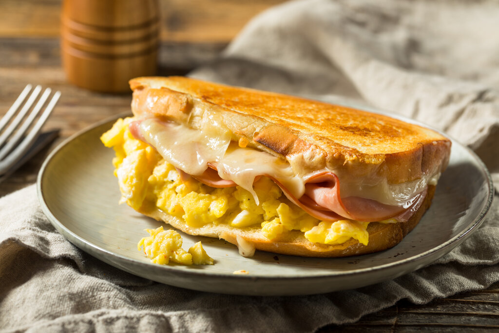 Moons Over My Hammy Recipe (Denny's Copycat), delicious egg sandwich with ham and melting cheese in betwee sourdough bread